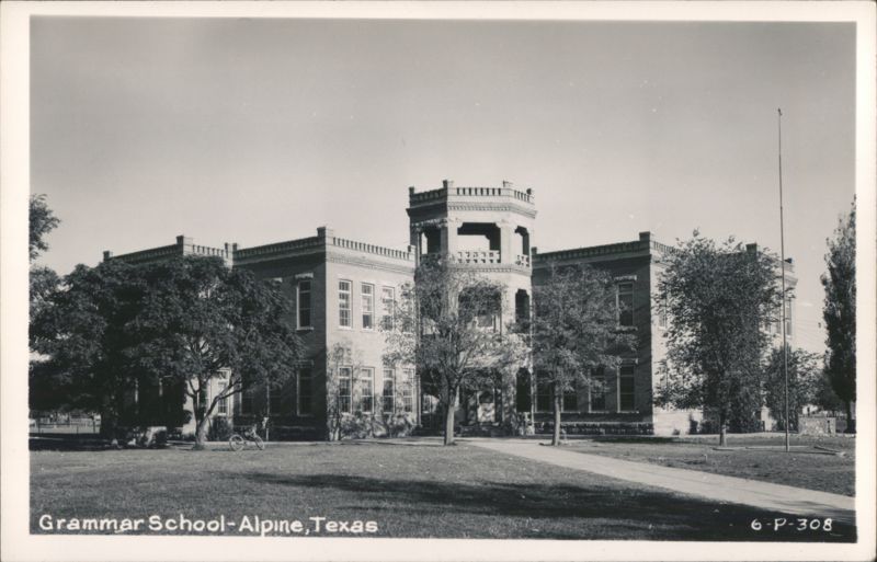 Grammar School building with prominent tower, trees, and sidewalk Alpine Texas