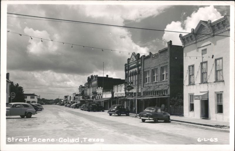 Goliad Main Street with Historic Buildings, Businesses, and Parked Cars Texas