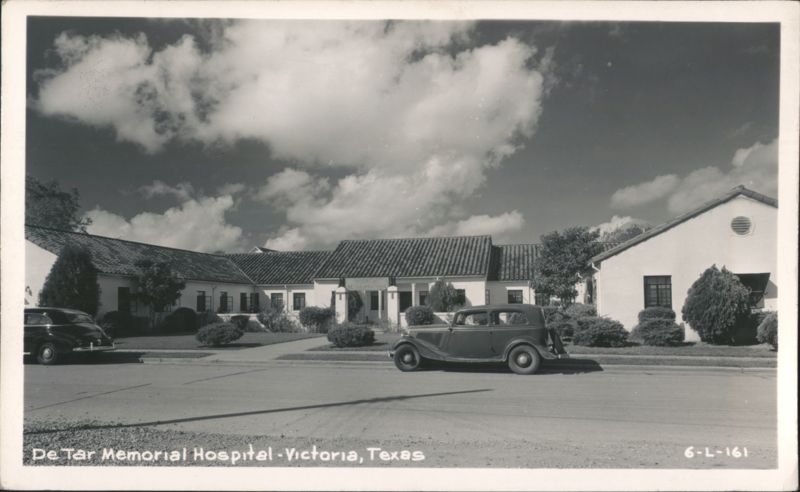 De Tar Memorial Hospital with two cars parked on the street Victoria Texas