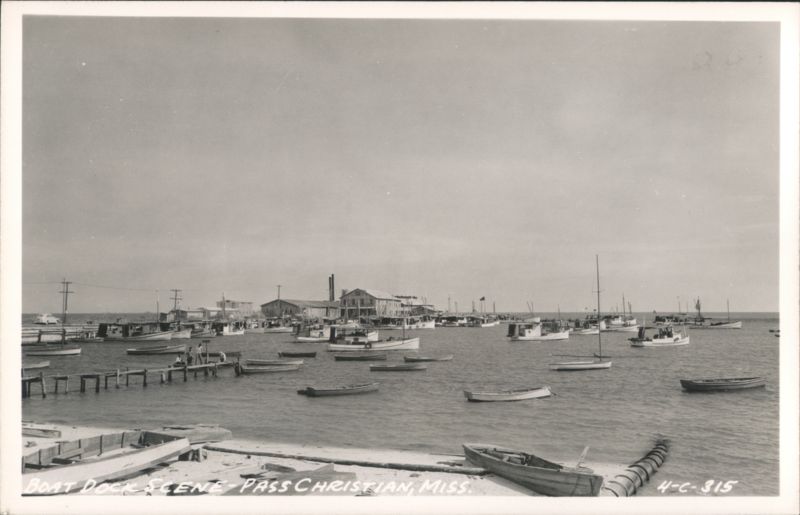 Boat Dock Scene with numerous fishing boats and buildings along the shore Pass Christian Mississippi