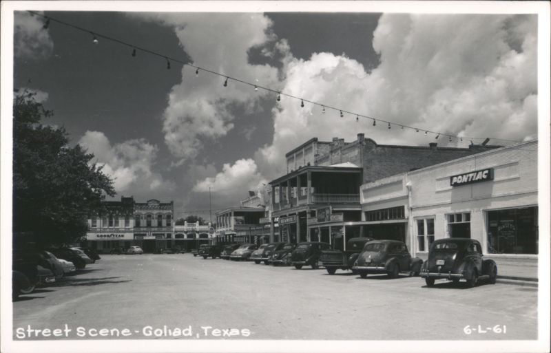 Street Scene with Vintage Cars and Storefronts Goliad Texas