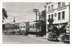 Trade Street with Missildine's Drugs, Ballenger's, and vintage cars Postcard