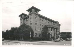 Park Terrace Hotel, a multi-story brick building with two towers Postcard