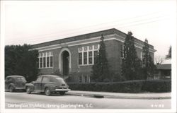 Darlington Public Library with two cars parked on the street Postcard