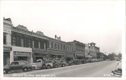 Darlington Street Scene with McLellan's, B.F. Goodrich, and men on roof Postcard