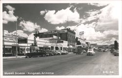 Main Street with Desert Drug, Frontier Cafe, Chevrolet-Buick, Vintage Cars Postcard
