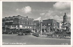 Street Scene with Businesses, Cars, and Courthouse Dome Postcard