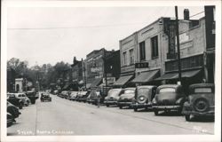 Downtown Sylva Street Scene with Businesses and Parked Cars Postcard