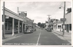 Downtown Street View with Shops and Vintage Cars Postcard