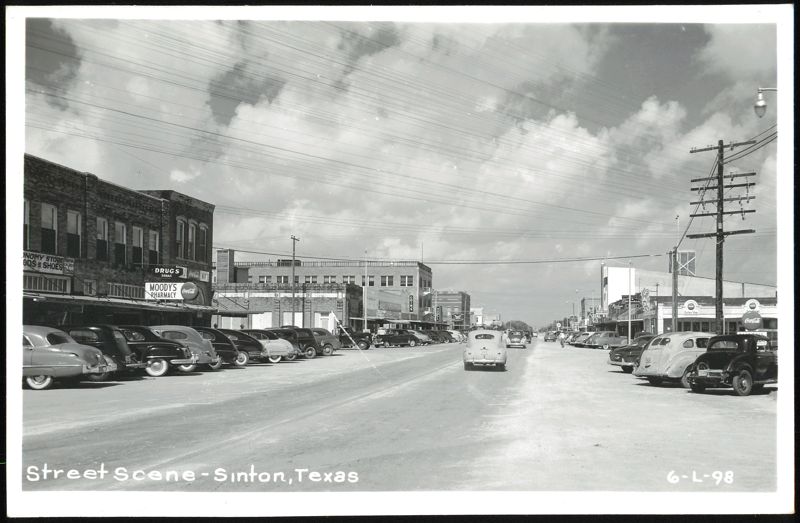 Downtown Street Scene with Vintage Cars and Businesses Sinton Texas
