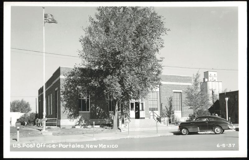 U.S. Post Office building, flag, and car Portales New Mexico