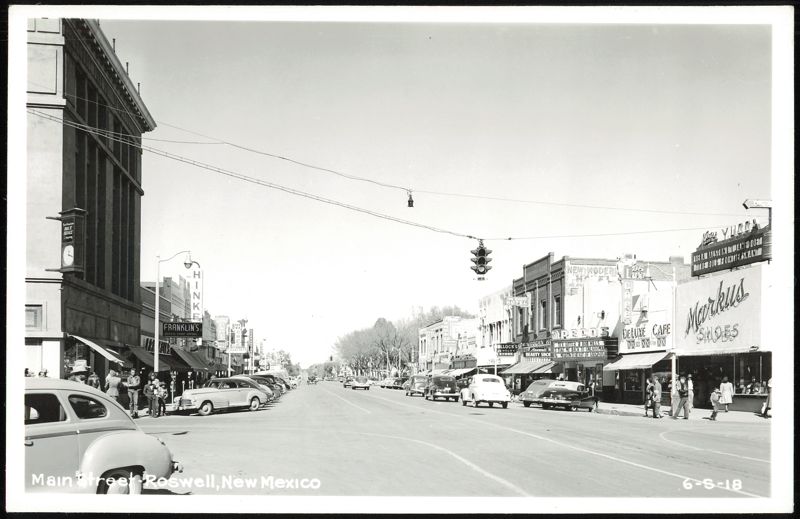Main Street with numerous cars and storefronts Roswell New Mexico