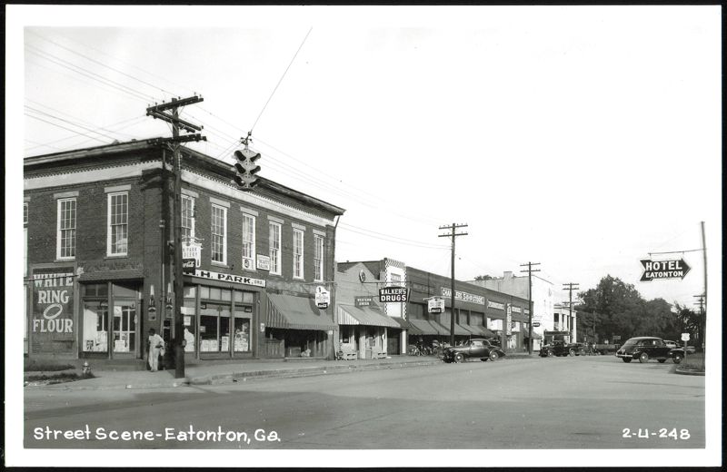 Downtown street scene with businesses and parked cars Eatonton Georgia