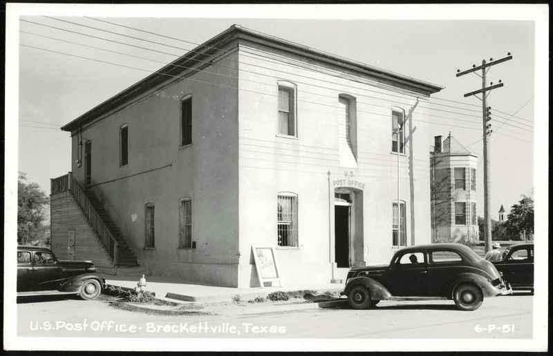 U.S. Post Office building with cars parked on street Brackettville Texas