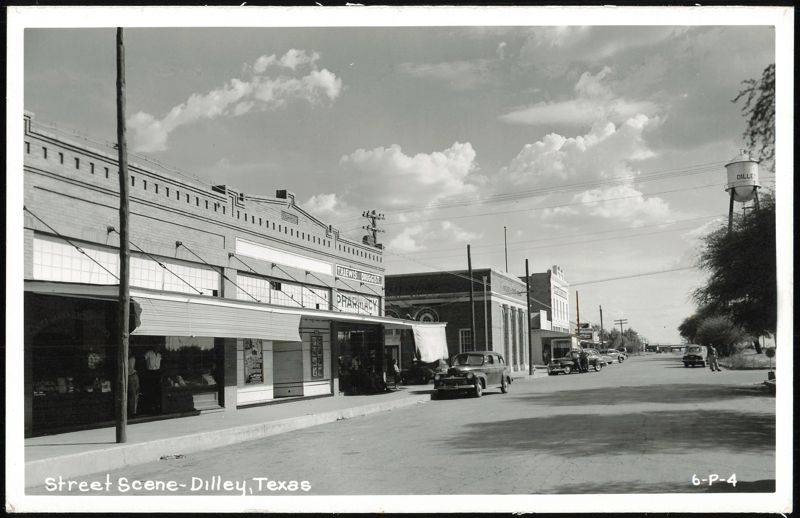 Street Scene with T.H. Lewis Druggist and Water Tower Dilley Texas