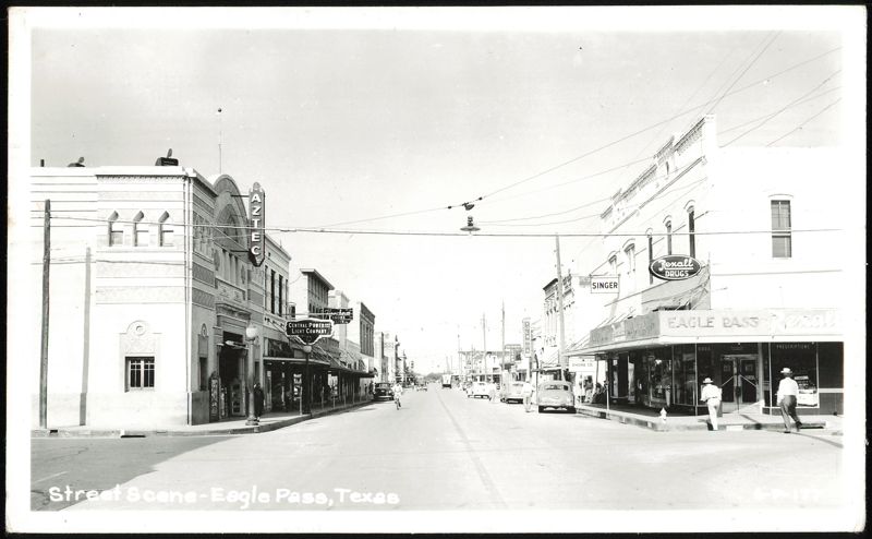Main Street with Aztec Theater, Rexall Drugs, and various businesses Eagle Pass Texas