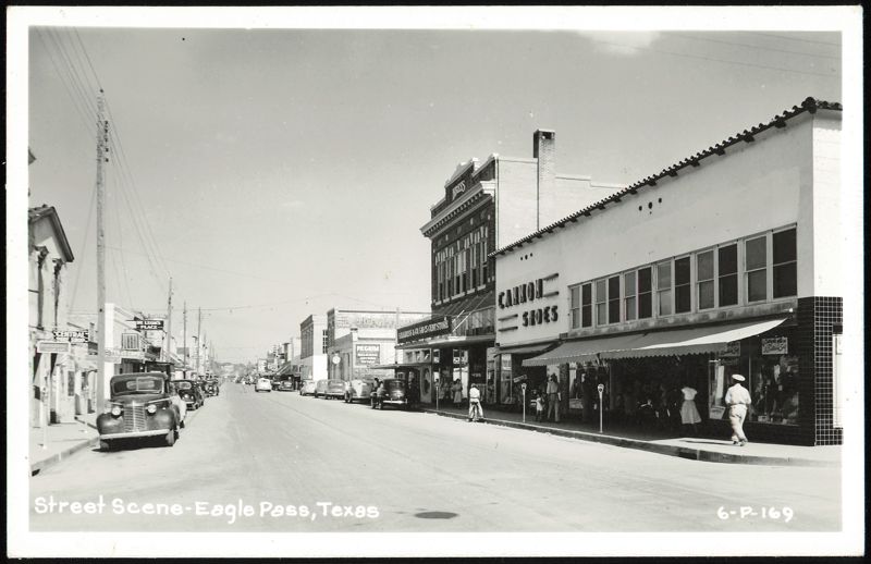 Downtown Street Scene with Shops and Parked Cars Eagle Pass Texas
