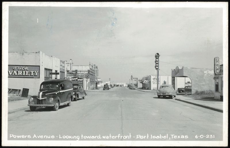 Powers Avenue, looking toward waterfront, with businesses and cars Port Isabel Texas