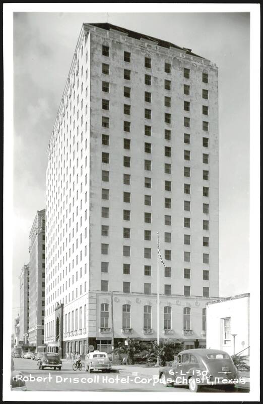 Robert Driscoll Hotel - Tall Building with Cars and Flag Corpus Christi Texas
