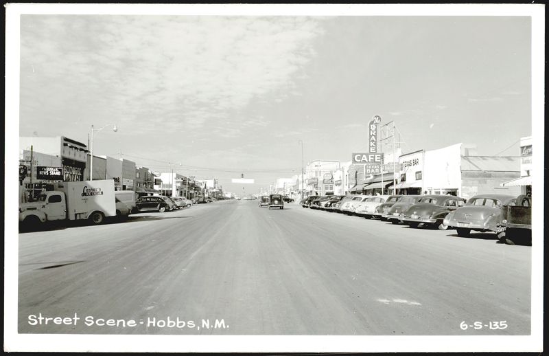 Street Scene with Drake Cafe, Texas Bar, and parked cars Hobbs New Mexico