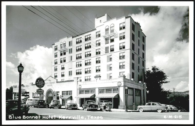 Blue Bonnet Hotel, street view with cars and shops Kerrville Texas