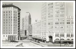 Downtown Business Section with Plaza Hotel and S.A. Drug Co. Water Tower Postcard
