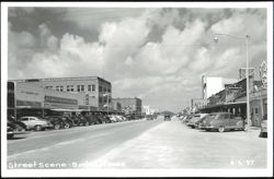 Street Scene with Storefronts and Parked Cars Postcard