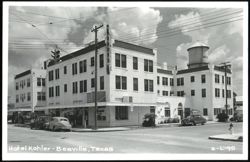 Hotel Kohler, Beeville, TX with vintage cars and water tower Postcard