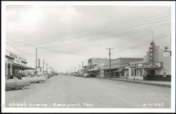 Street scene with Surf Theater, Johnson's Drug Store, and businesses Postcard