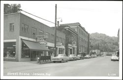 Street Scene with Cavalier Drugs and Western Auto Store Postcard