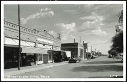 Street Scene with T.H. Lewis Druggist and Water Tower Postcard