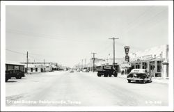 Street Scene in Hebbronville, Texas with businesses and vintage cars Postcard