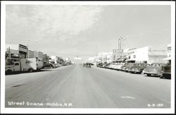 Street Scene with Drake Cafe, Texas Bar, and parked cars Postcard