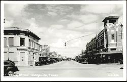 Kleberg Street Downtown Scene with Businesses and Parked Cars Postcard