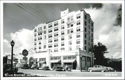 Blue Bonnet Hotel, street view with cars and shops Postcard