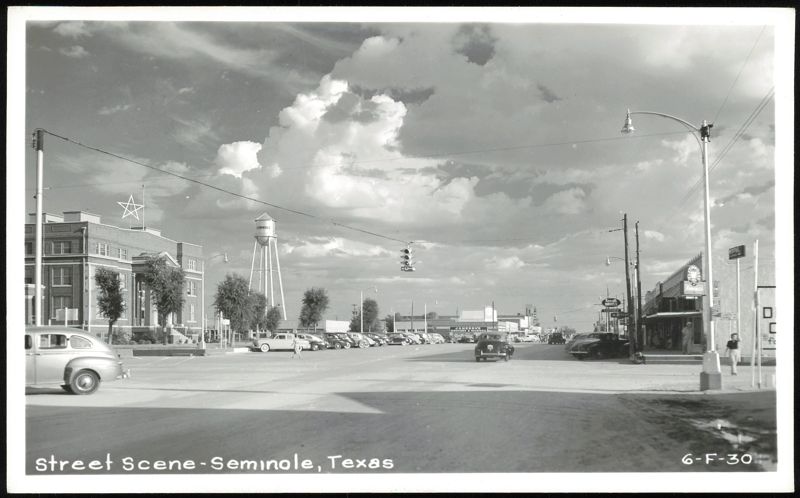 Street Scene with Water Tower, Star Building, and Cars Seminole Texas