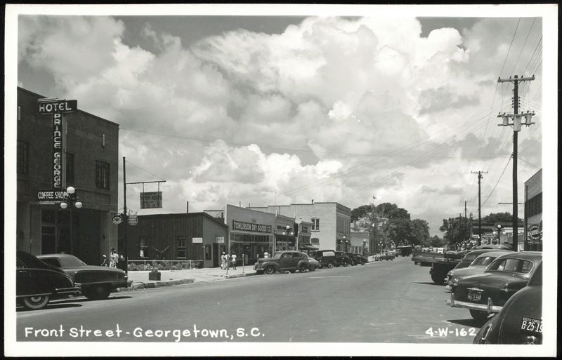 Front Street with Hotel Prince George and Tomlinson Dry Goods Co.