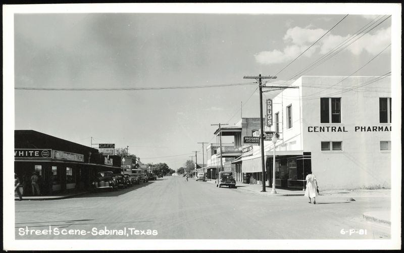 Downtown Street Scene with Shops and Parked Cars Sabinal Texas
