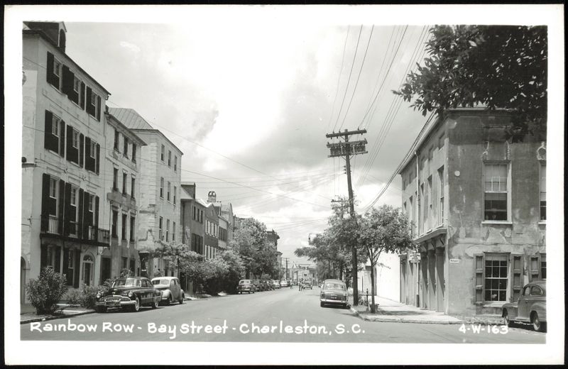 Rainbow Row and Bay Street street scene with historic buildings and cars Charleston South Carolina