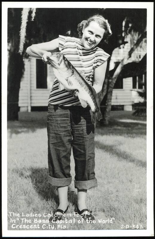 Woman proudly holding a large bass fish, Crescent City, Florida
