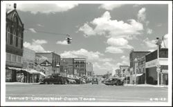 Avenue D Looking West - Street Scene with Various Shops and Cars Postcard