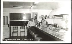 Guy Brewer Cafe interior with man at counter and woman behind counter Postcard