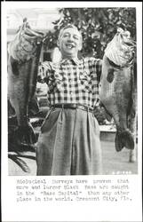 Man with Two Large Black Bass Fish, Crescent City, Florida Postcard