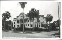 Hotel Dunedin, large white building with columns and palm trees Postcard