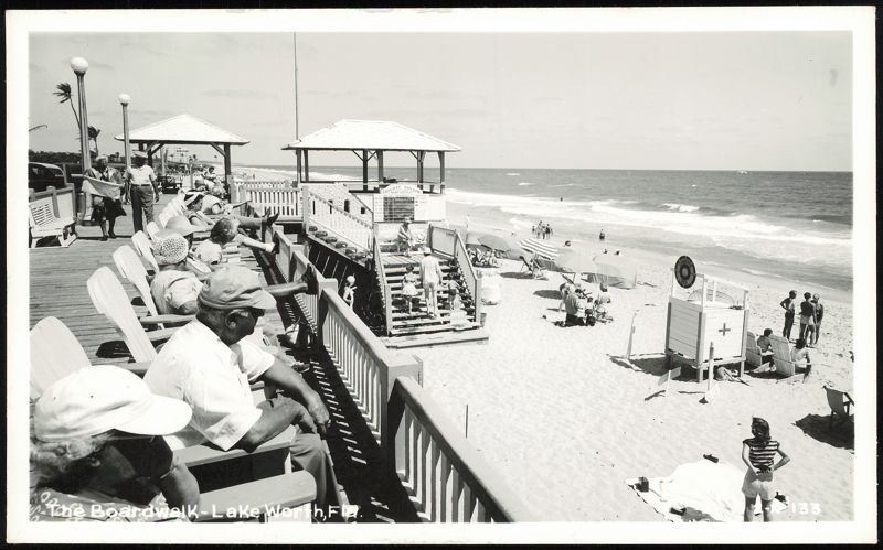 People Relaxing on Boardwalk Overlooking Beach Lake Worth Florida