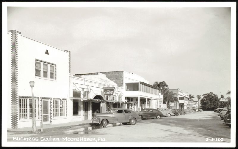 Business Section with Storefronts and Parked Cars