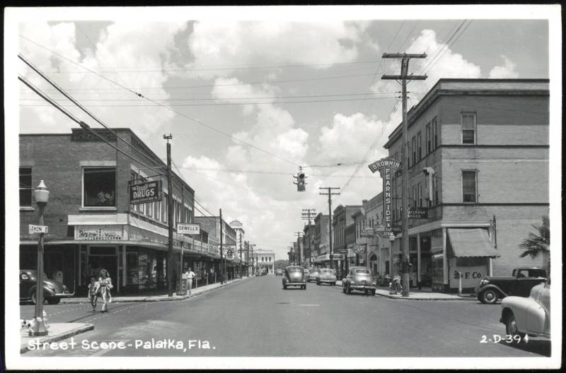 Downtown Lemon Street Scene with Stores and Cars