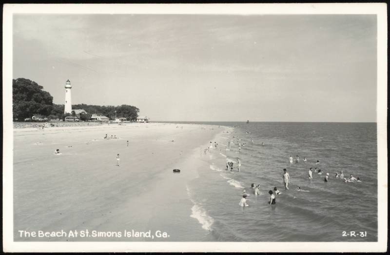 Beach Scene with Lighthouse and Swimmers Saint Simons Georgia