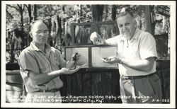 Charles Sullivan and Jack Raymon Holding Baby Water Snakes Postcard
