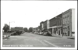 Downtown Street Scene with Stores and Parked Cars Postcard
